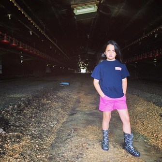 Craig Watts standing in a dark empty chicken house