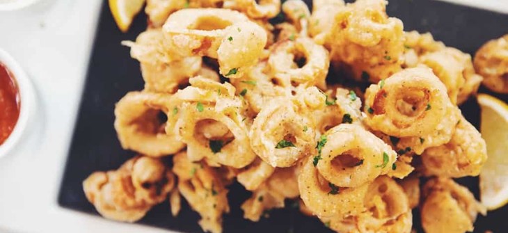 tower of fried oyster mushroom rounds on a platter