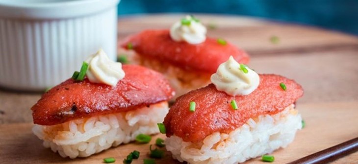 Marinated tomato on nugget of sushi rice topped with swirl of tofu mayo