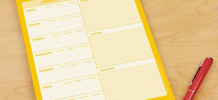 (Credit: Book Depository) Yellow stationary sits on pine table next to red pen. text on stationary is white and reads " What to eat"