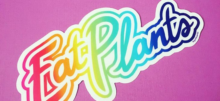(Credit: VeganPowerCo.) Rainbow sticker with white outline script reads "Eat Plants" on a purple background