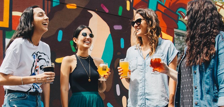 group of people with beer glasses in hand