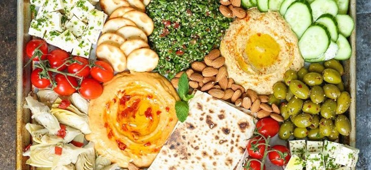 Snack spread with Hummus, Babaganouch. Tzatziki, and assorted crackers