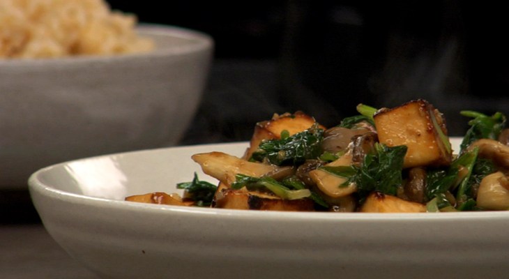 Mushroom and tofu stir fry in a white bowl