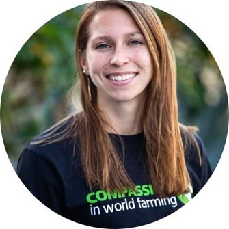 Nicole smiling at the camera, wearing a black Compassion in World Farming t-shirt