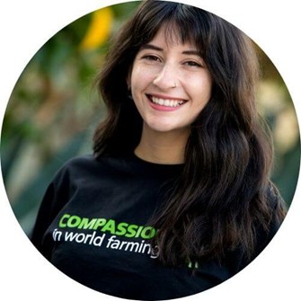 Audry smiling at the camera. wearing a black Compassion in World Farming t-shirt