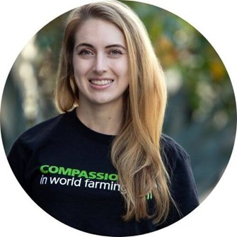 Allie Molinaro smiles at the camera wearing a Compassion in World Farming t-shirt.