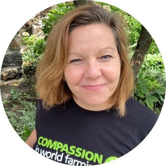 Callie smiling at the camera, wearing a Compassion in World Farming t-shirt