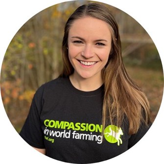 Kourtney smiling at the camera, wearing a black Compassion in World Farming t-shirt