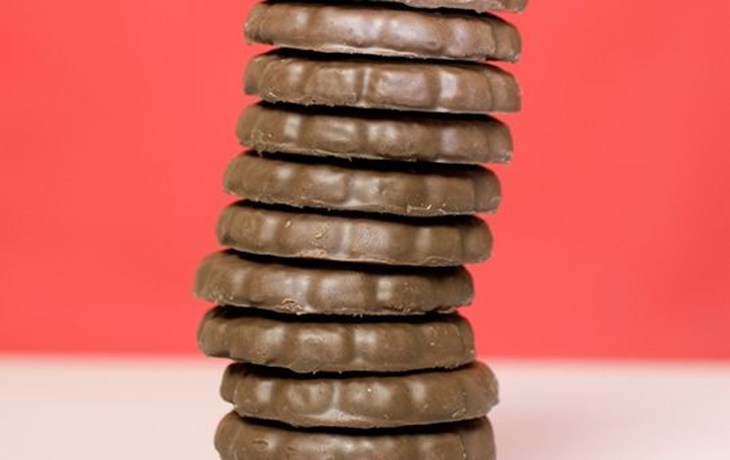 Thin mints stacked in front of a red backdrop