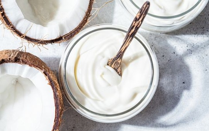 Coconut yogurt with a wooden spoon