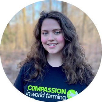 Madison smiling at the camera, wearing a black Compassion in World Farming t-shirt
