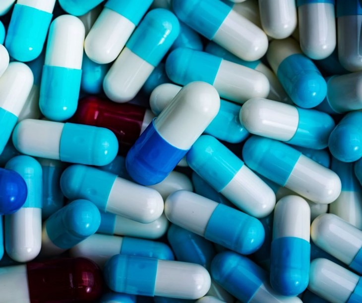 A pile of blue and white pills.