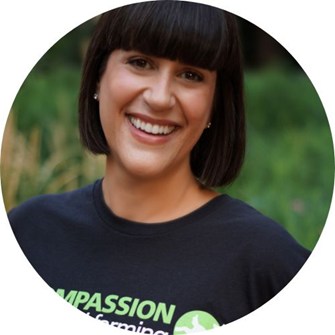 Ro Conder smiles at the camera while wearing a black Compassion in World Farming t-shirt.