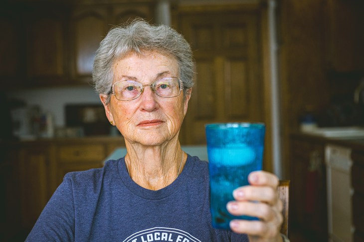 Virginia Drath holds up a glass of water and ice.