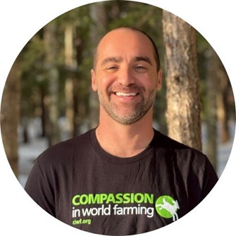 Matthew Dominguez smiles at the camera wearing a Compassion in World Farming t-shirt.