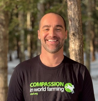 A headshot of Matthew Dominguez outside with pine trees in the background.